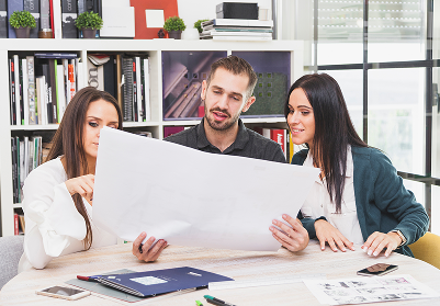 Team reviewing a layout at a table